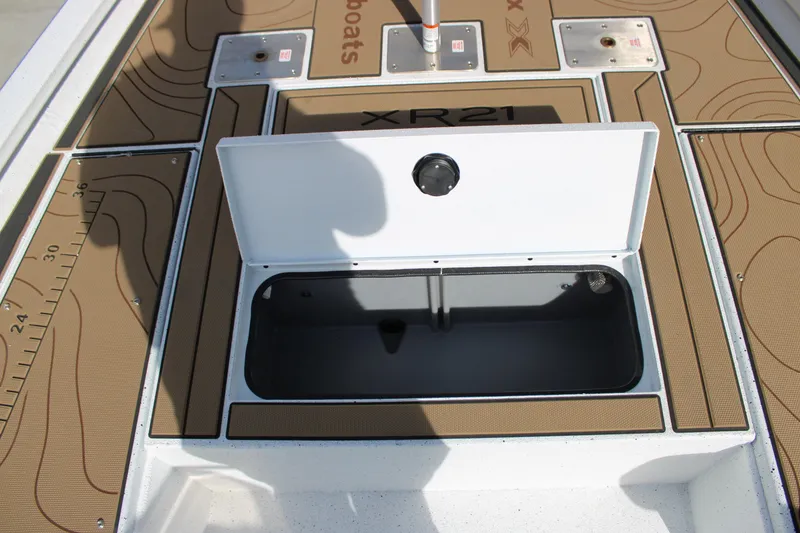 Slide: The Image of 2026 Xpress XR21B Bay boat deck with open storage compartment. - 12