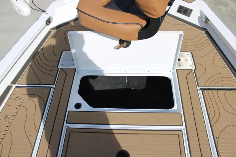 Slide: The Image of 2026 Xpress XR21B Bay boat deck with storage compartment and tan seating. - 13