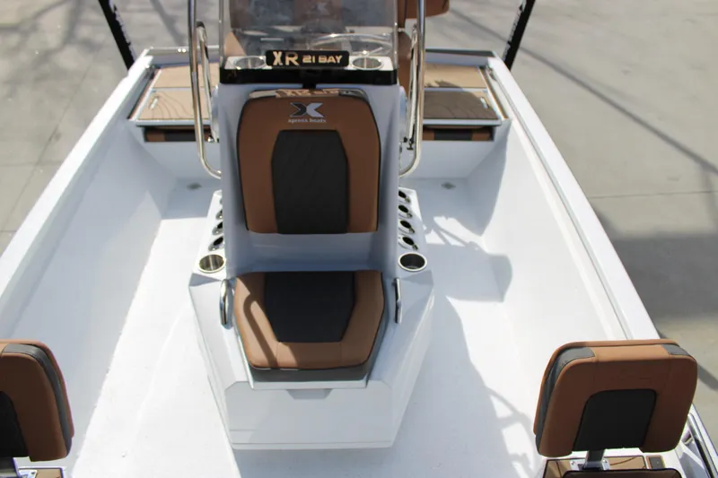 Slide: The Image of 2026 Xpress XR21B Bay boat interior with brown and black seating, showcasing modern design. - 14