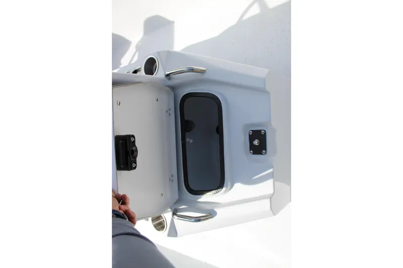 Slide: The Image of 2026 Xpress XR21B Bay boat storage compartment with handle and latch. - 16