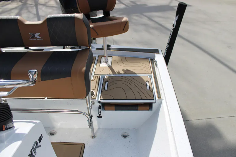 Slide: The Image of 2026 Xpress XR21B Bay boat interior with stylish seating and storage compartments. - 17
