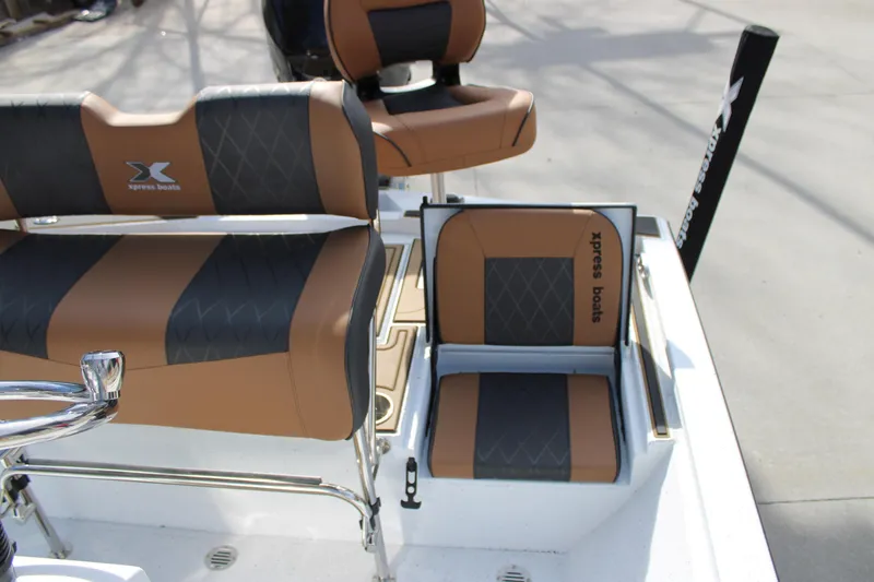 Slide: The Image of 2026 Xpress XR21B Bay boat interior with stylish brown and black seating. - 18