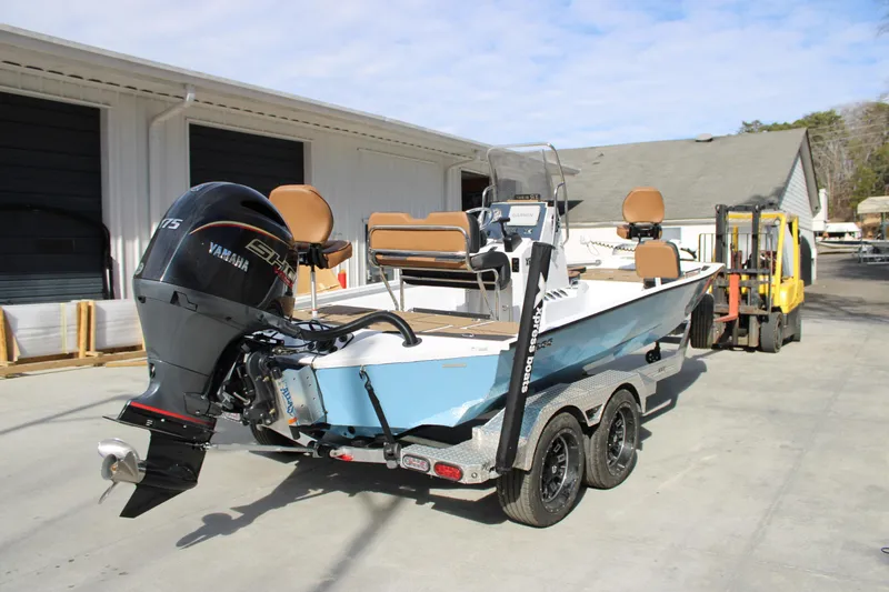 Slide: The Image of 2026 Xpress XR21B Bay boat with Yamaha engine on trailer, parked outdoors. - 4