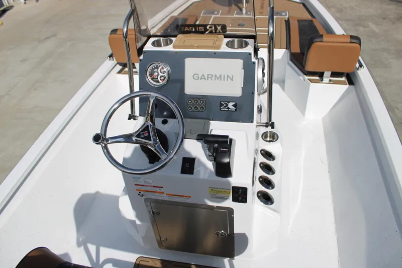 Slide: The Image of 2026 Xpress XR21B Bay boat console with Garmin navigation and steering wheel. - 6