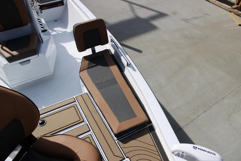 Slide: The Image of 2026 Xpress XR21B Bay boat interior with brown seating and Minn Kota equipment. - 9