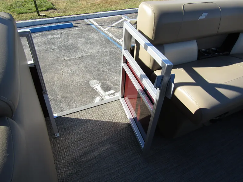 Slide: The Image of 2024 Starcraft LX 20 R boat interior with open side gate and beige seating. - 11