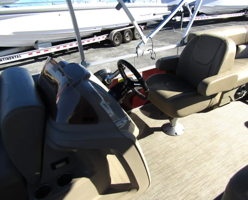 Slide: The Image of 2024 Starcraft LX 20 R boat interior with steering wheel and seating. - 12