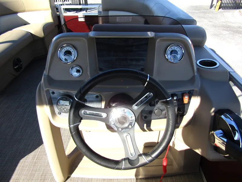 Slide: The Image of 2024 Starcraft LX 20 R boat dashboard with steering wheel and controls. - 13