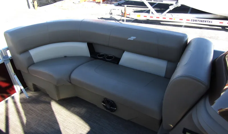 Slide: The Image of 2024 Starcraft LX 20 R pontoon boat interior with gray seating and cup holders. - 10