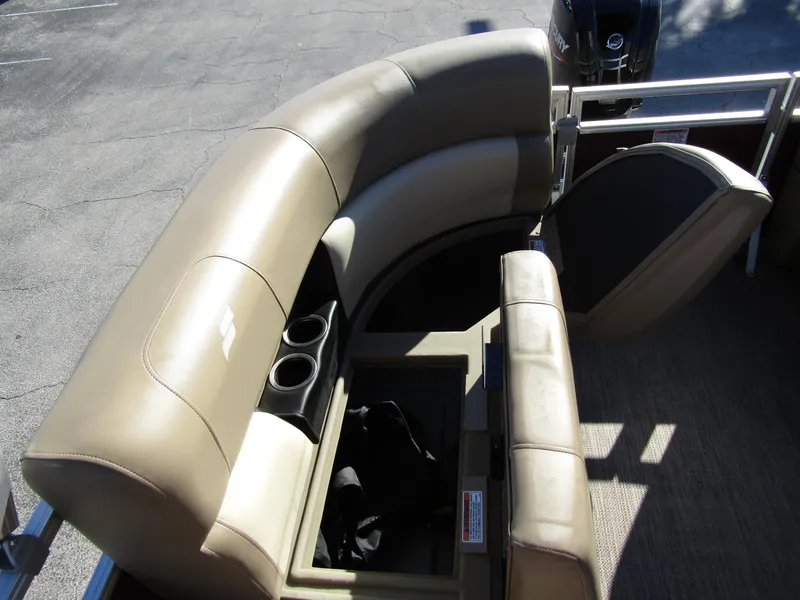 Slide: The Image of 2024 Starcraft LX 20 R boat interior with beige seating and storage compartment. - 21