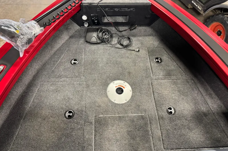 Slide: The Image of 2026 Tracker Targa V-19 WT boat interior with carpeted deck and wiring. - 16