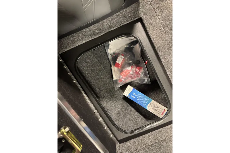 Slide: The Image of Storage compartment in 2026 Tracker Targa V-19 WT boat with accessories and packaging. - 19