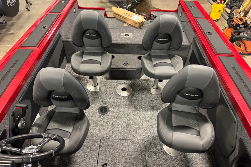 Slide: The Image of 2026 Tracker Targa V-19 WT boat interior with four gray seats and red accents. - 21