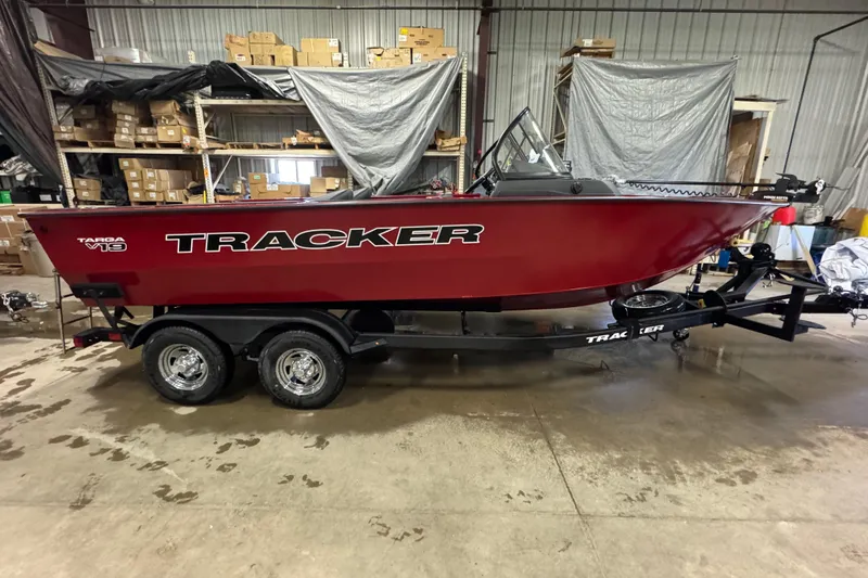 Slide: The Image of 2026 Tracker Targa V-19 WT boat in warehouse, red exterior, on trailer. - 3