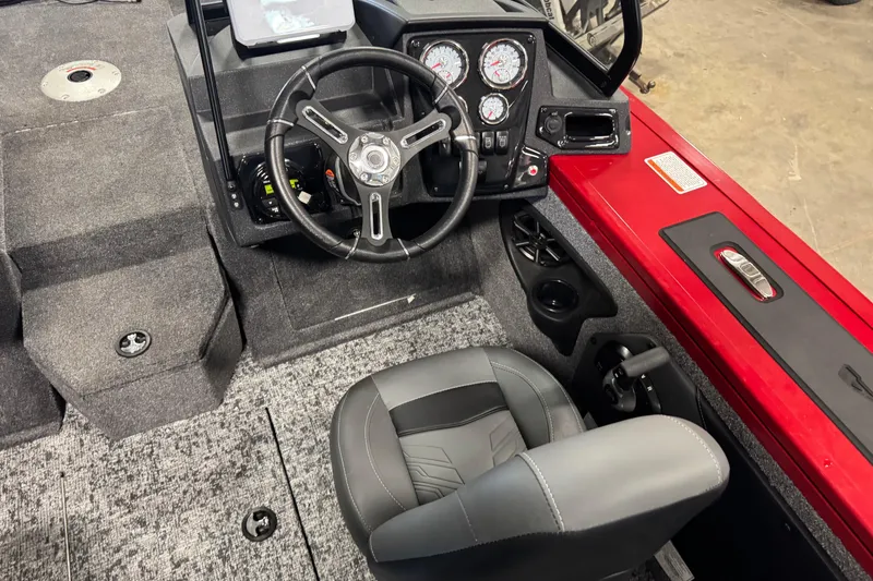 Slide: The Image of 2026 Tracker Targa V-19 WT boat interior with steering wheel and dashboard controls. - 6
