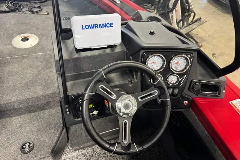 Slide: The Image of 2026 Tracker Targa V-19 WT boat dashboard with Lowrance display and steering wheel. - 9