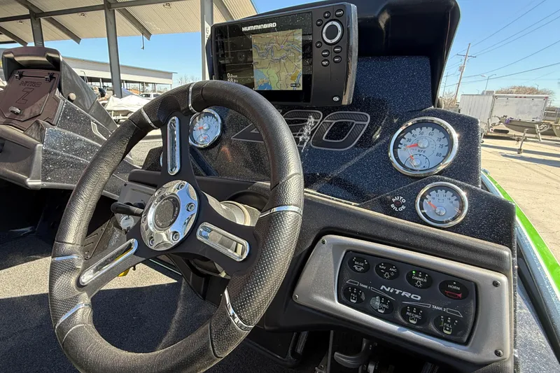 Slide: The Image of Steering wheel and dashboard of a 2020 Nitro Z20 boat with navigation display. - 16