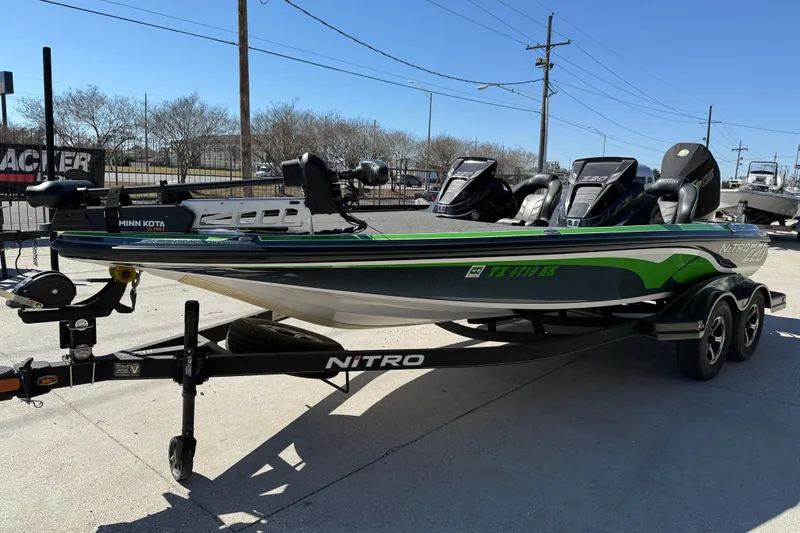 Slide: The Image of 2020 Nitro Z20 fishing boat with Minn Kota motor on trailer, parked outdoors. - 4