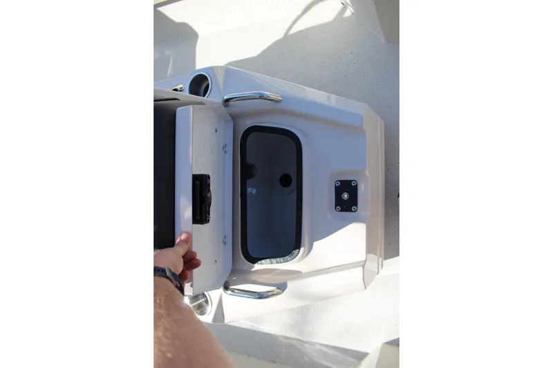 Slide: The Image of 2026 Xpress H20B Bay boat storage compartment with open lid and handle. - 11
