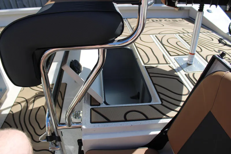 Slide: The Image of 2026 Xpress H20B Bay boat interior with open storage compartment and stylish seating. - 15