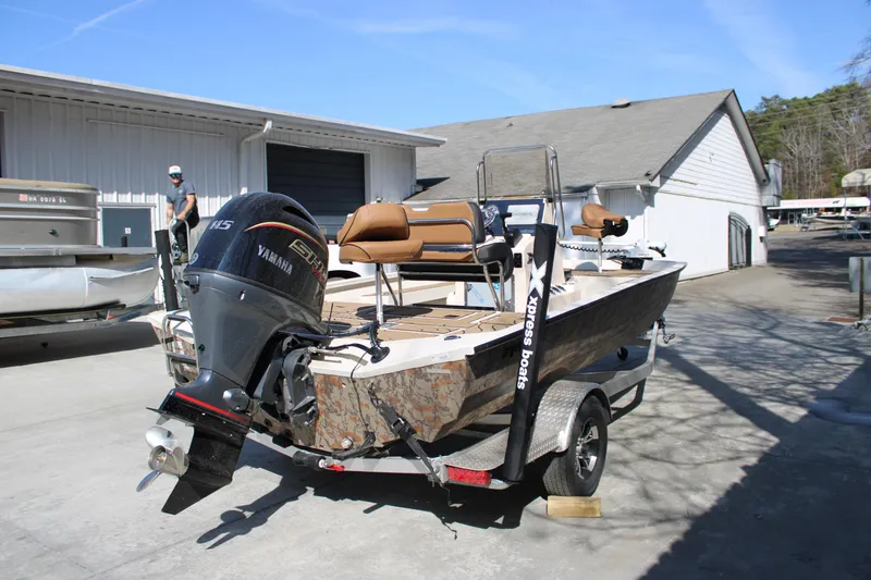 Slide: The Image of 2026 Xpress H20B Bay boat with Yamaha motor on trailer, parked outdoors. - 4