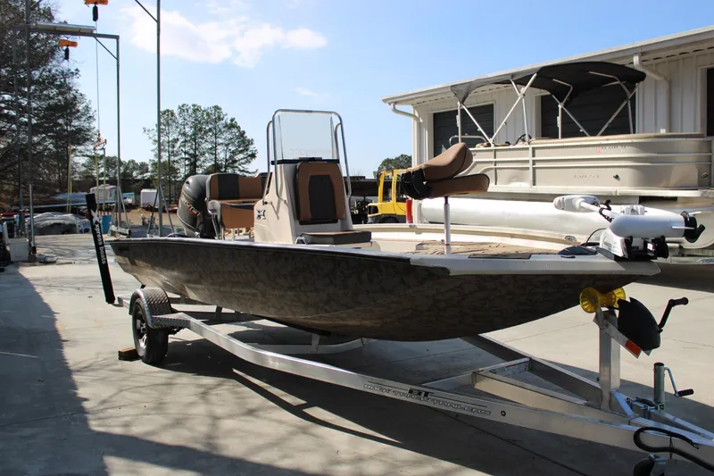 Slide: The Image of 2026 Xpress H20B Bay boat on trailer, parked outdoors under clear sky. - 5