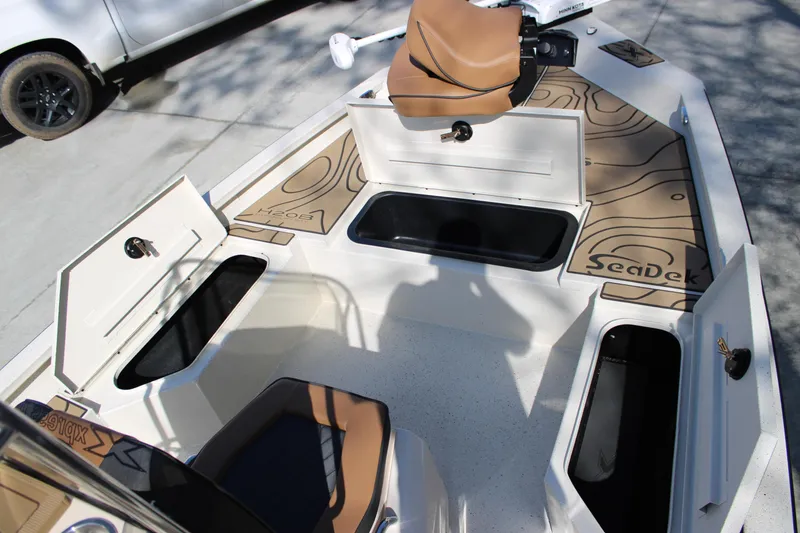 Slide: The Image of 2026 Xpress H20B Bay boat interior with storage compartments and SeaDek flooring. - 8