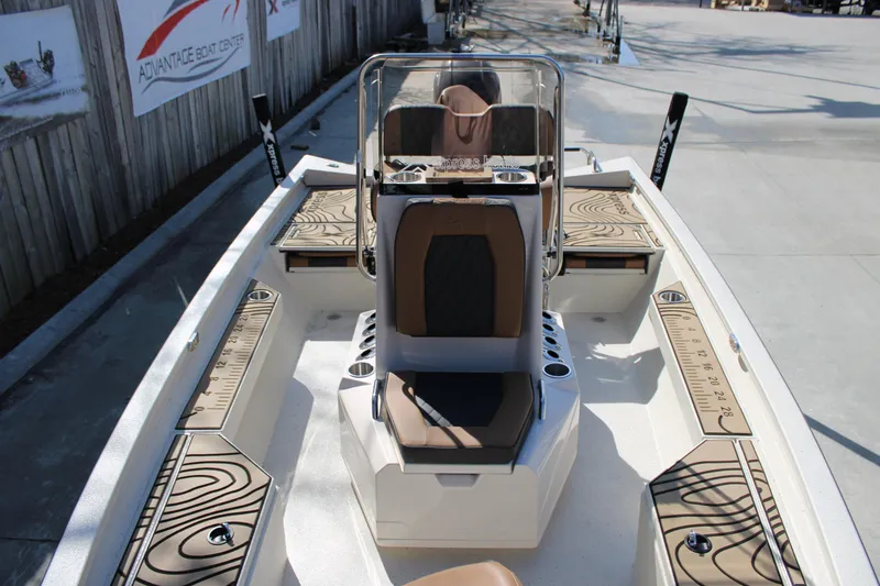 Slide: The Image of 2026 Xpress H20B Bay boat interior with seating and storage compartments. - 9