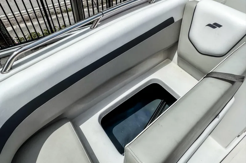 Slide: The Image of 2024 Starcraft SVX 211 OB boat interior with cushioned seating and storage compartment. - 13