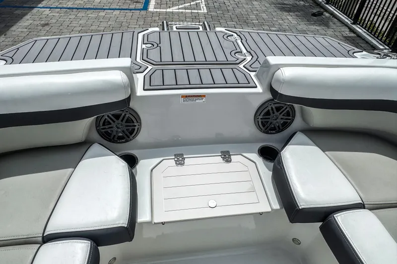 Slide: The Image of 2024 Starcraft SVX 211 OB boat interior with cushioned seating and speakers. - 16