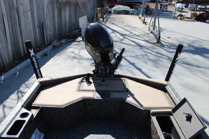 Slide: The Image of 2026 Xpress X18DB boat with motor, docked on a sunny day. - 14