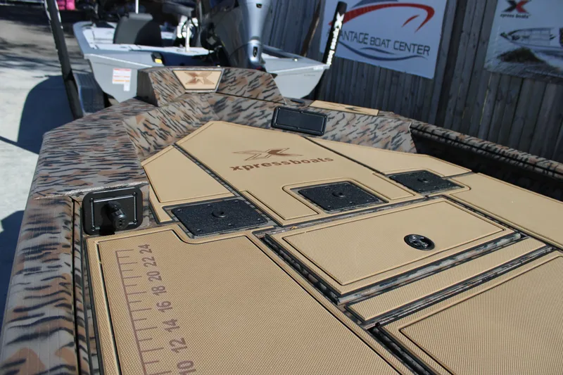 Slide: The Image of 2026 Xpress X18DB boat deck with camouflage design and storage compartments. - 5