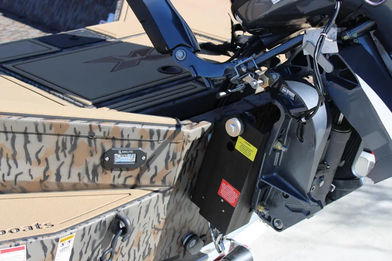 Slide: The Image of 2026 Xpress X18DB boat with camouflage design and motor detail. - 6