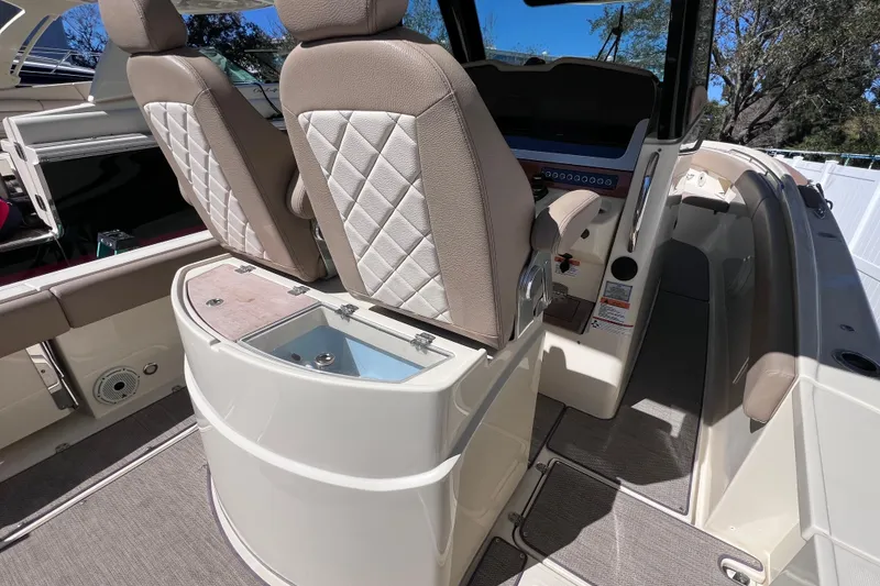 Slide: The Image of 2022 Chris-Craft Catalina 30 interior with luxurious seating and modern dashboard. - 17