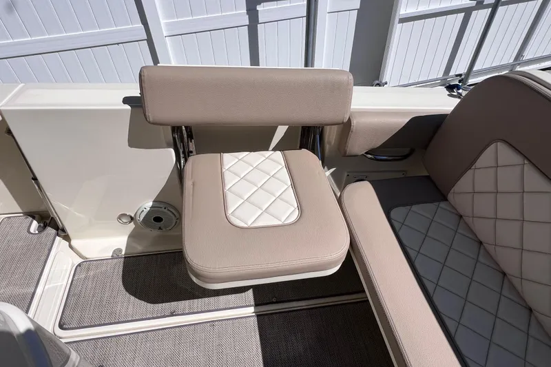 Slide: The Image of 2022 Chris-Craft Catalina 30 boat seating with beige and white quilted upholstery. - 22