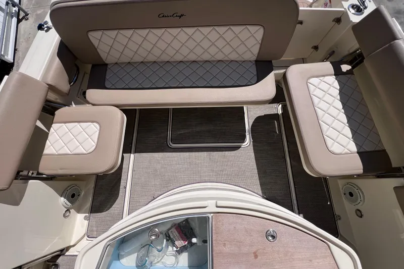 Slide: The Image of 2022 Chris-Craft Catalina 30 interior with beige quilted seating and storage compartments. - 23