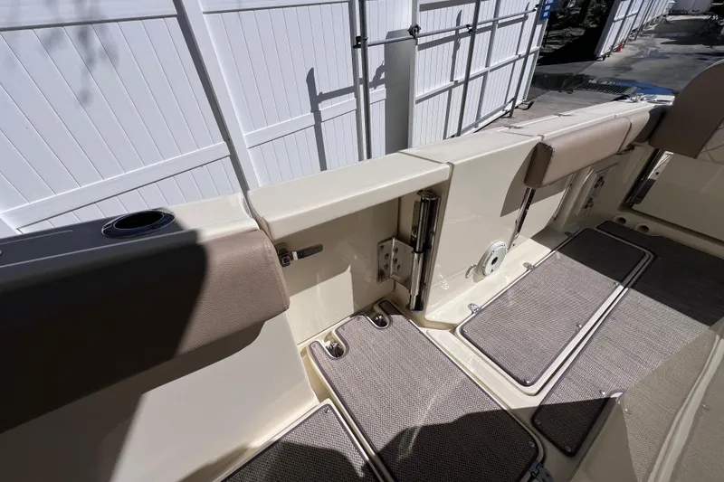 Slide: The Image of 2022 Chris-Craft Catalina 30 boat interior with cushioned seating and deck mats. - 29