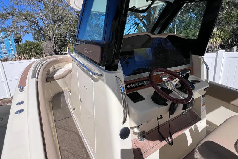 Slide: The Image of 2022 Chris-Craft Catalina 30 boat interior with steering wheel and navigation system. - 33