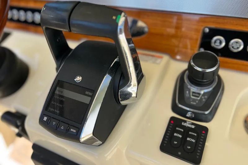 Slide: The Image of Control panel of 2022 Chris-Craft Catalina 30 boat, featuring throttle and joystick. - 35