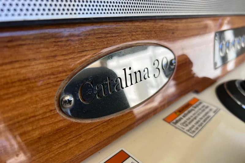 Slide: The Image of 2022 Chris-Craft Catalina 30 nameplate on polished wood surface. - 37