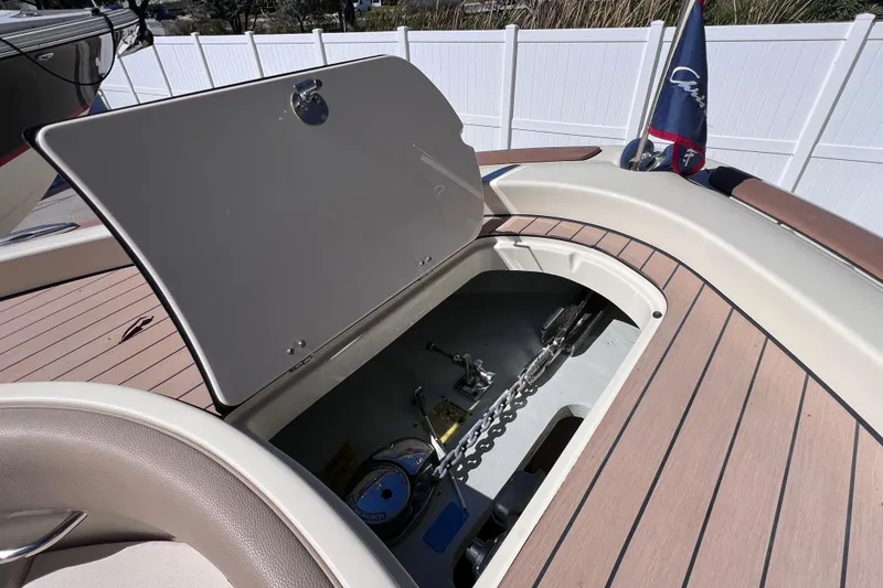 Slide: The Image of 2022 Chris-Craft Catalina 30 anchor storage compartment with open hatch, showcasing deck details. - 43