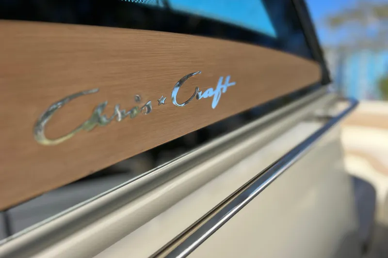 Slide: The Image of 2022 Chris-Craft Catalina 30 logo on wooden boat panel, close-up view. - 46
