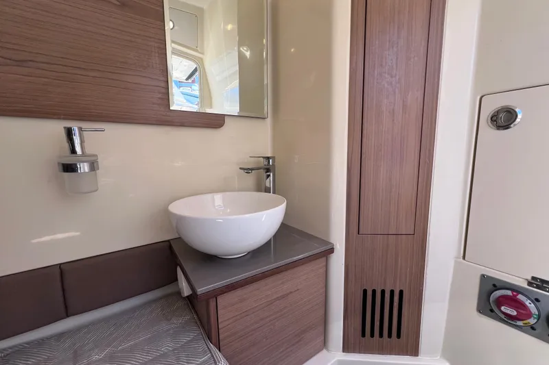 Slide: The Image of 2022 Chris-Craft Catalina 30 bathroom with modern sink and wooden accents. - 50
