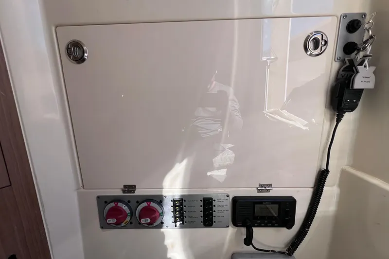 Slide: The Image of Control panel of 2022 Chris-Craft Catalina 30 boat with switches and radio. - 51