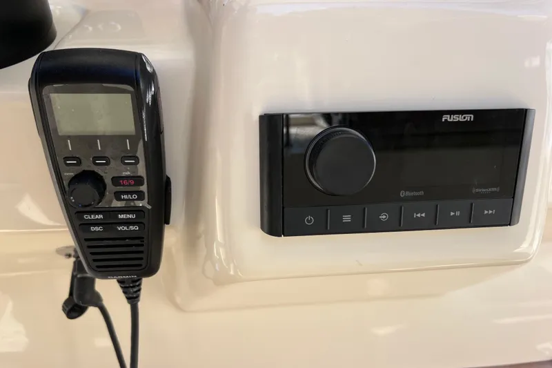 Slide: The Image of 2022 Chris-Craft Catalina 30 dashboard with radio and communication controls. - 57