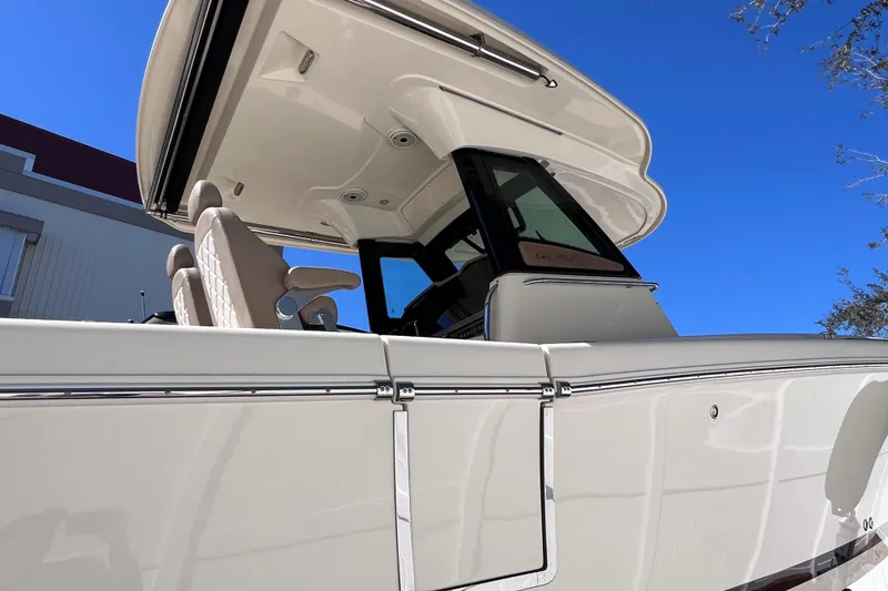 Slide: The Image of 2022 Chris-Craft Catalina 30 boat, sleek design, viewed from below against clear blue sky. - 6