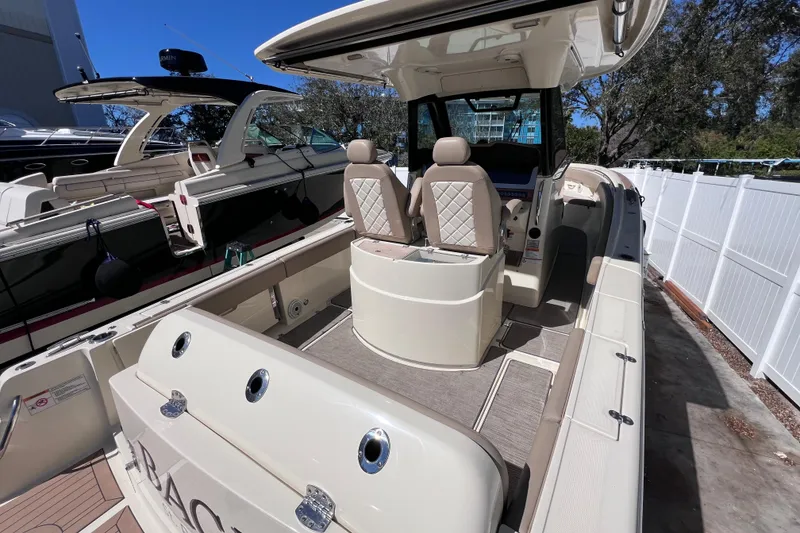 Slide: The Image of 2022 Chris-Craft Catalina 30 boat interior with seating and helm, docked outdoors. - 9