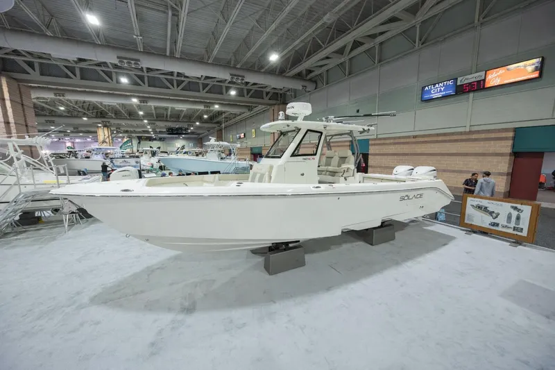 The Image of 2026 Solace 30 CS boat displayed at an indoor exhibition, showcasing sleek design and modern features. - 0