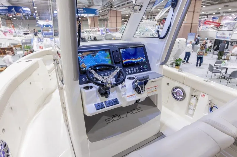 Slide: The Image of 2026 Solace 30 CS boat dashboard with advanced navigation system at a boat show. - 4