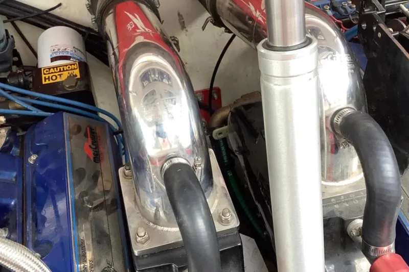 Slide: The Image of Engine components of a 1998 Donzi 33 ZX boat, featuring chrome and blue accents. - 10